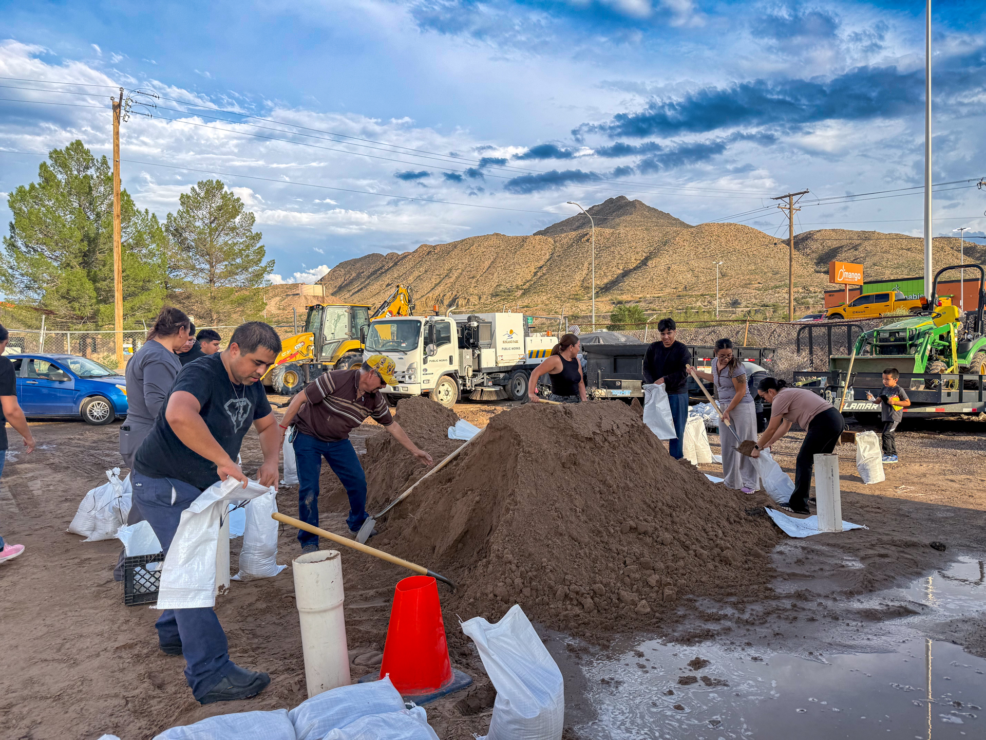 Community members fill sandbags in Sunland Park