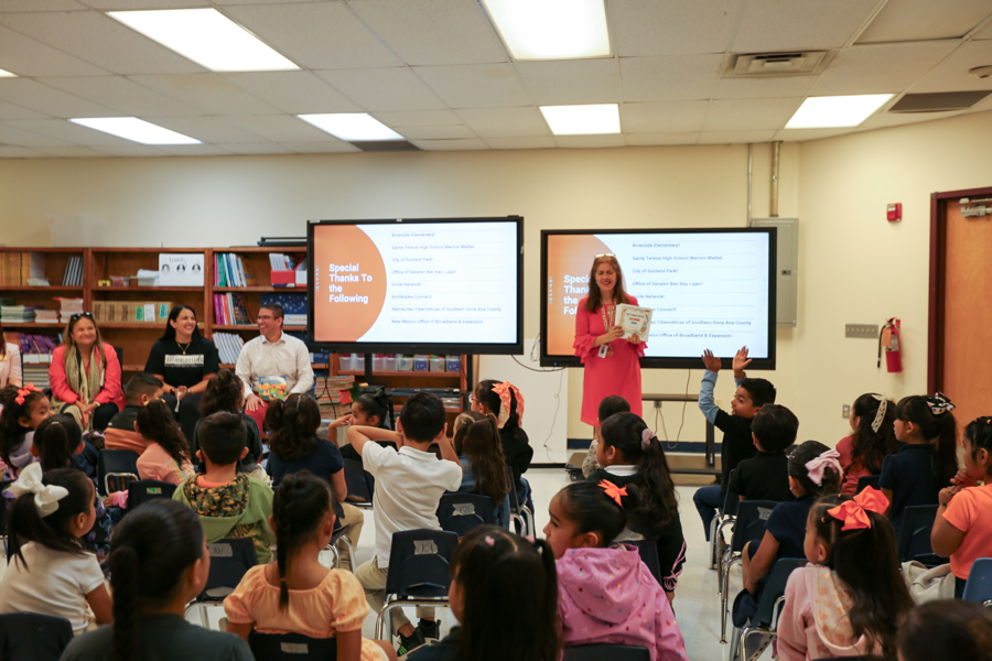 Students raise their hands as the activity wraps up with a thank-you to partners.