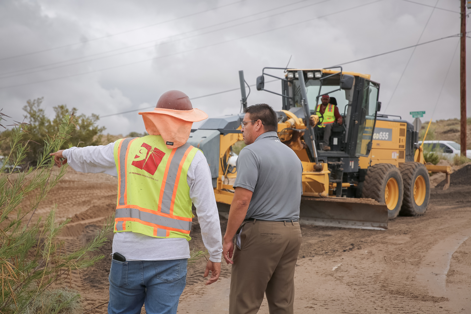 Heavy equipment clears a flooded roadway