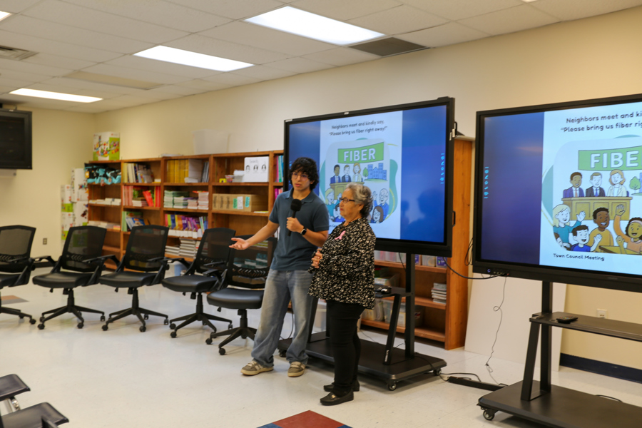 A Warrior Media student interviews one of the readers on camera.