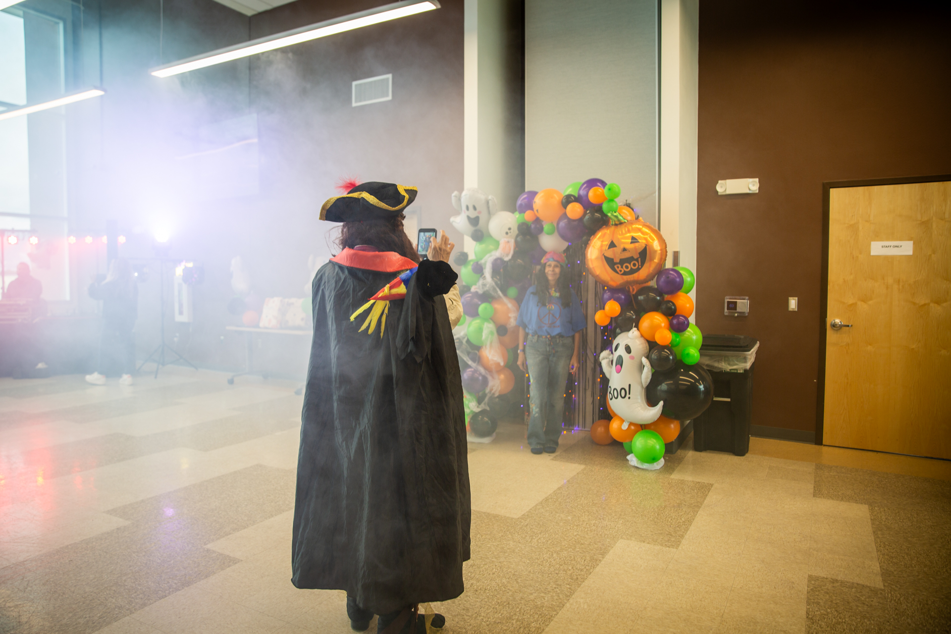 A caped figure surrounded by fog