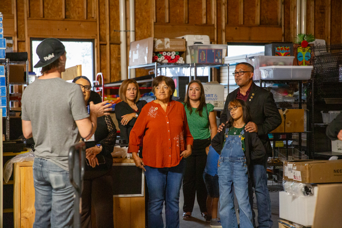 A speaker shares details while the group looks on.