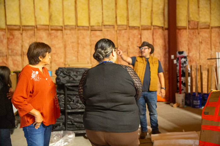 Council members listen during the warehouse tour.