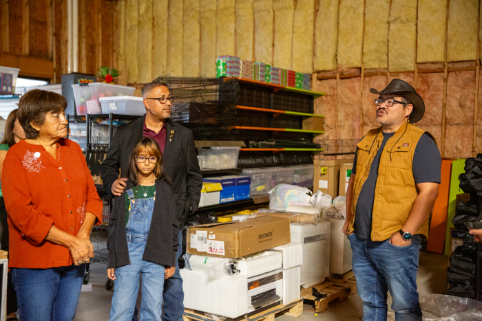 Council members and guests look over the warehouse space.