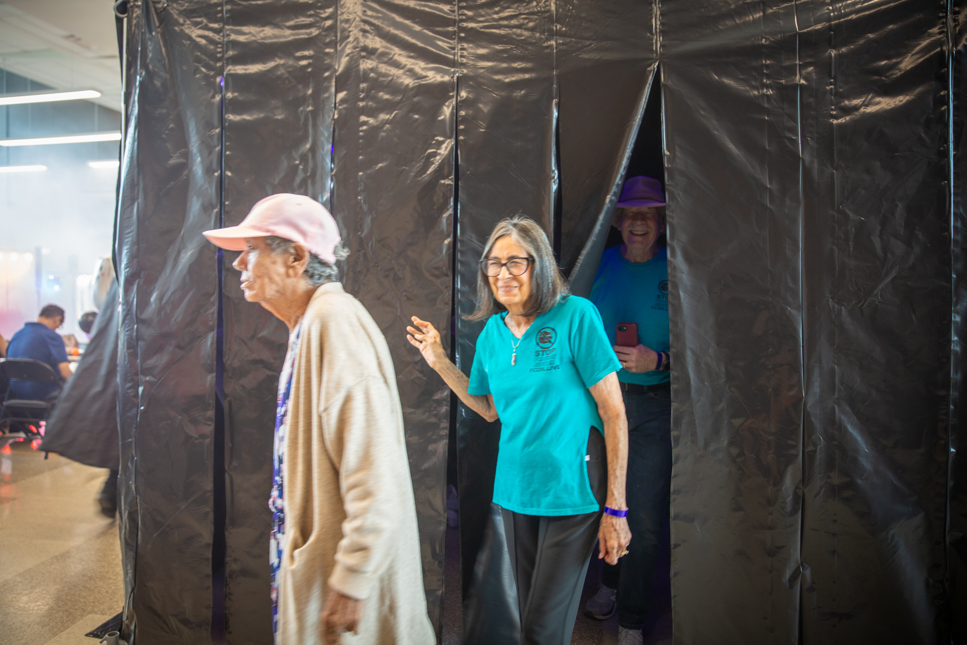 Guests emerging from the haunted house curtains