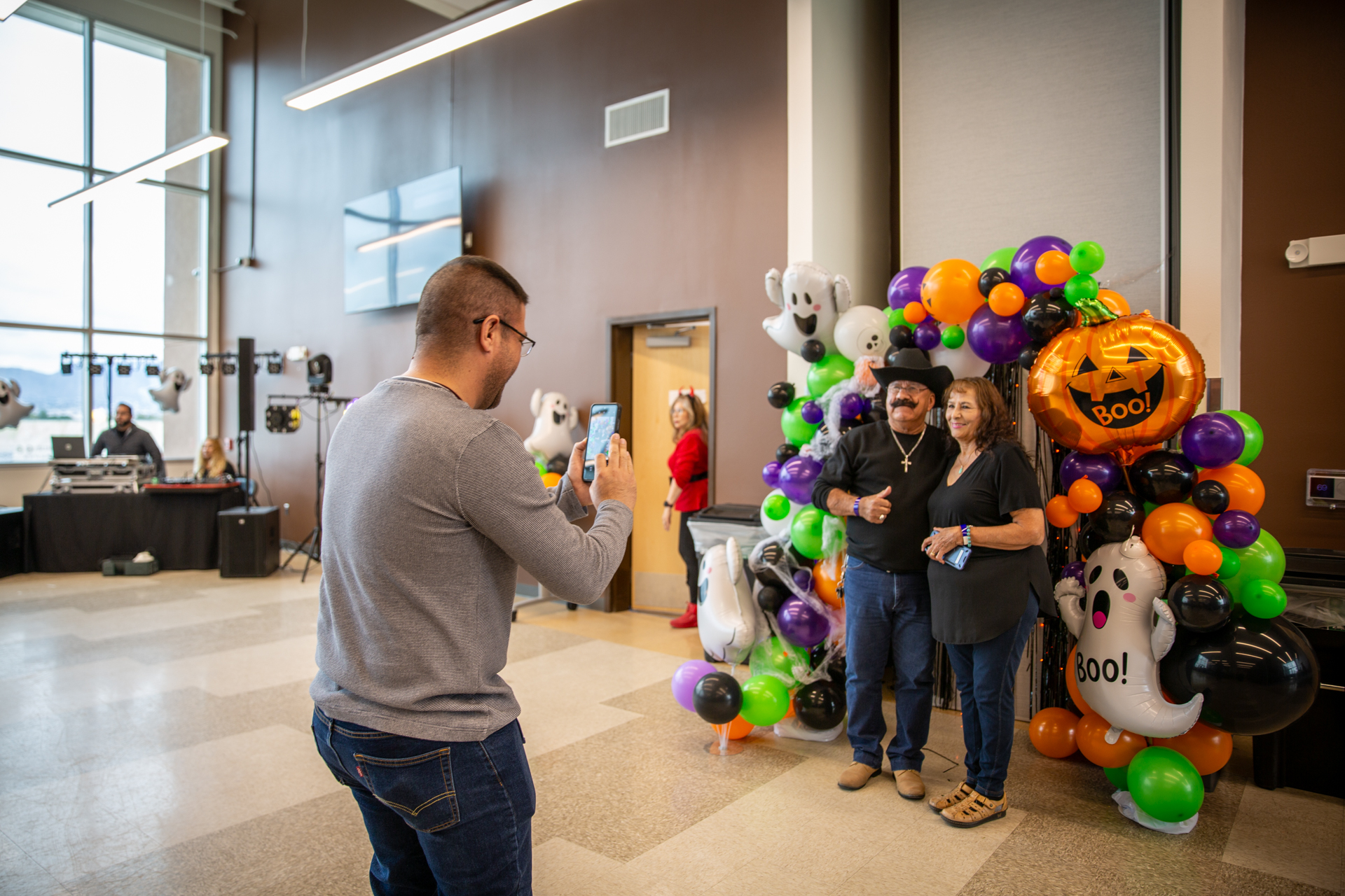A guest dancing in front of the balloon arch