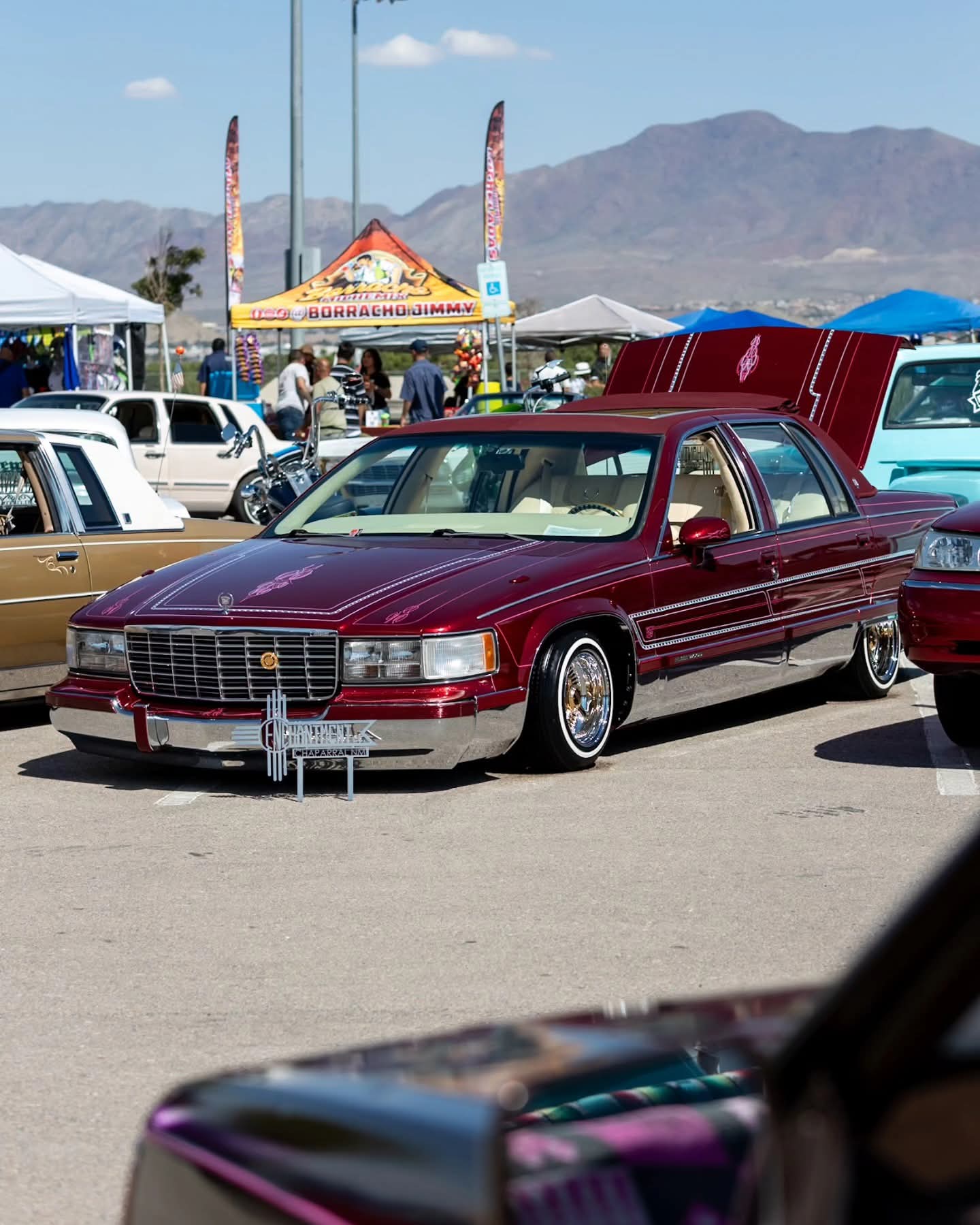 A candy-red Cadillac lowrider on display at last year's car show