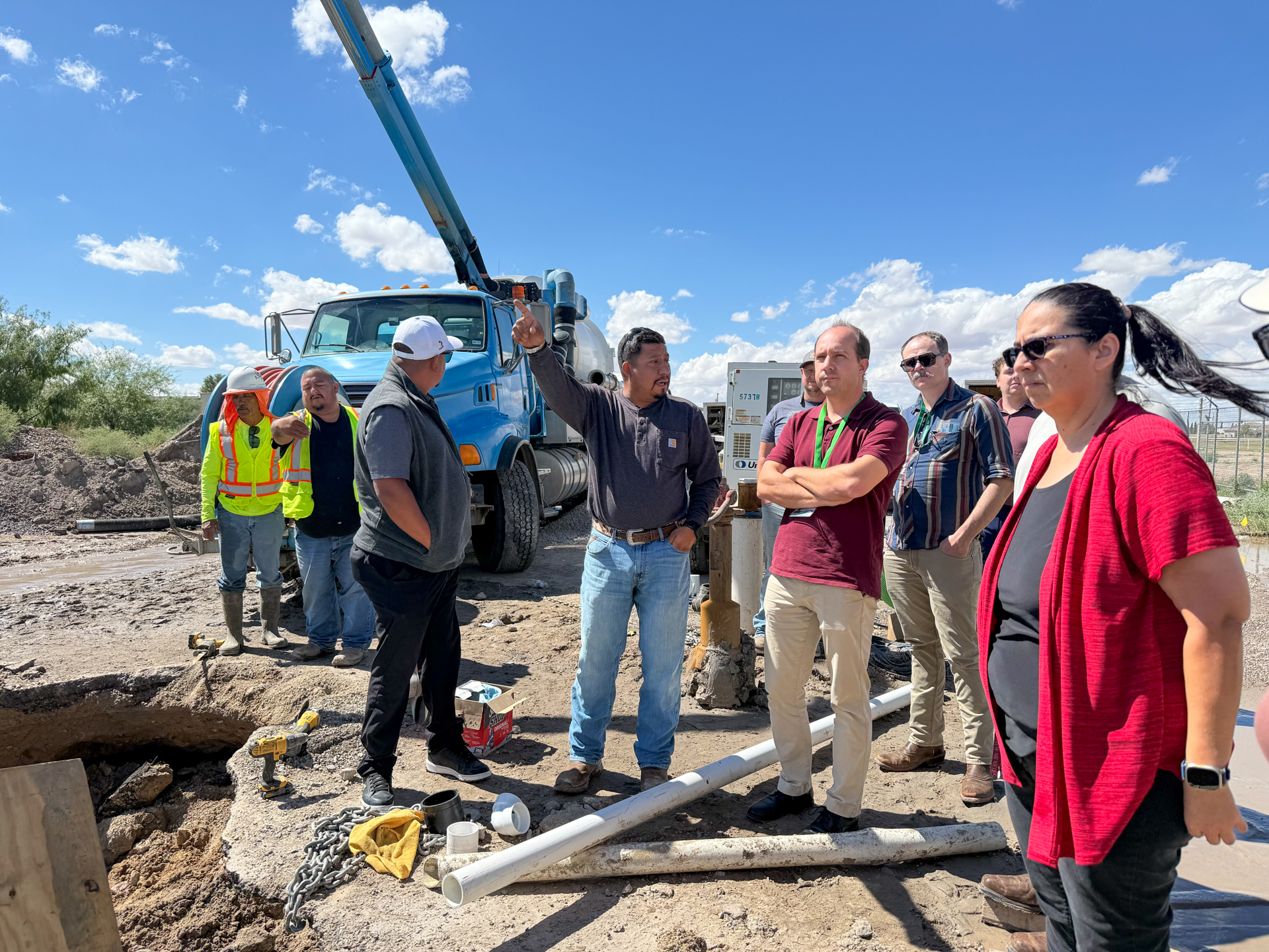 CRRUA crew members explaining manhole improvement work to tour participants