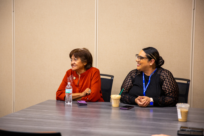 Councilor Maria Burciaga visits with another attendee during the workshop.