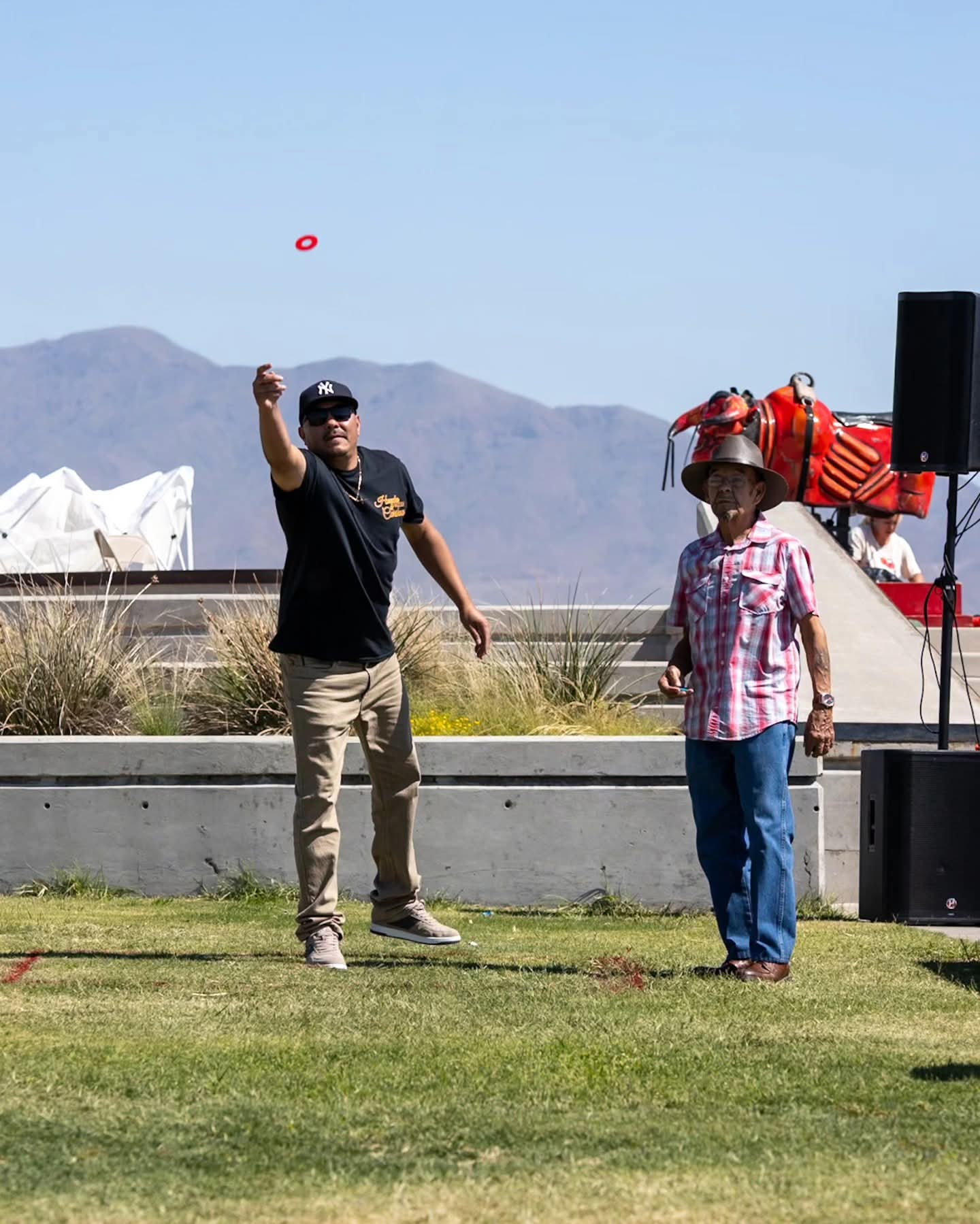 A player tosses a washer during last year's huacha tournament