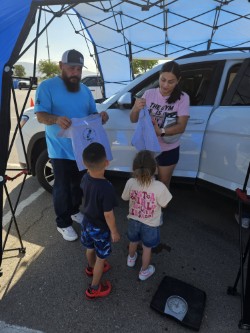 Parents and technicians working together during the August 29 car seat fitting station.
