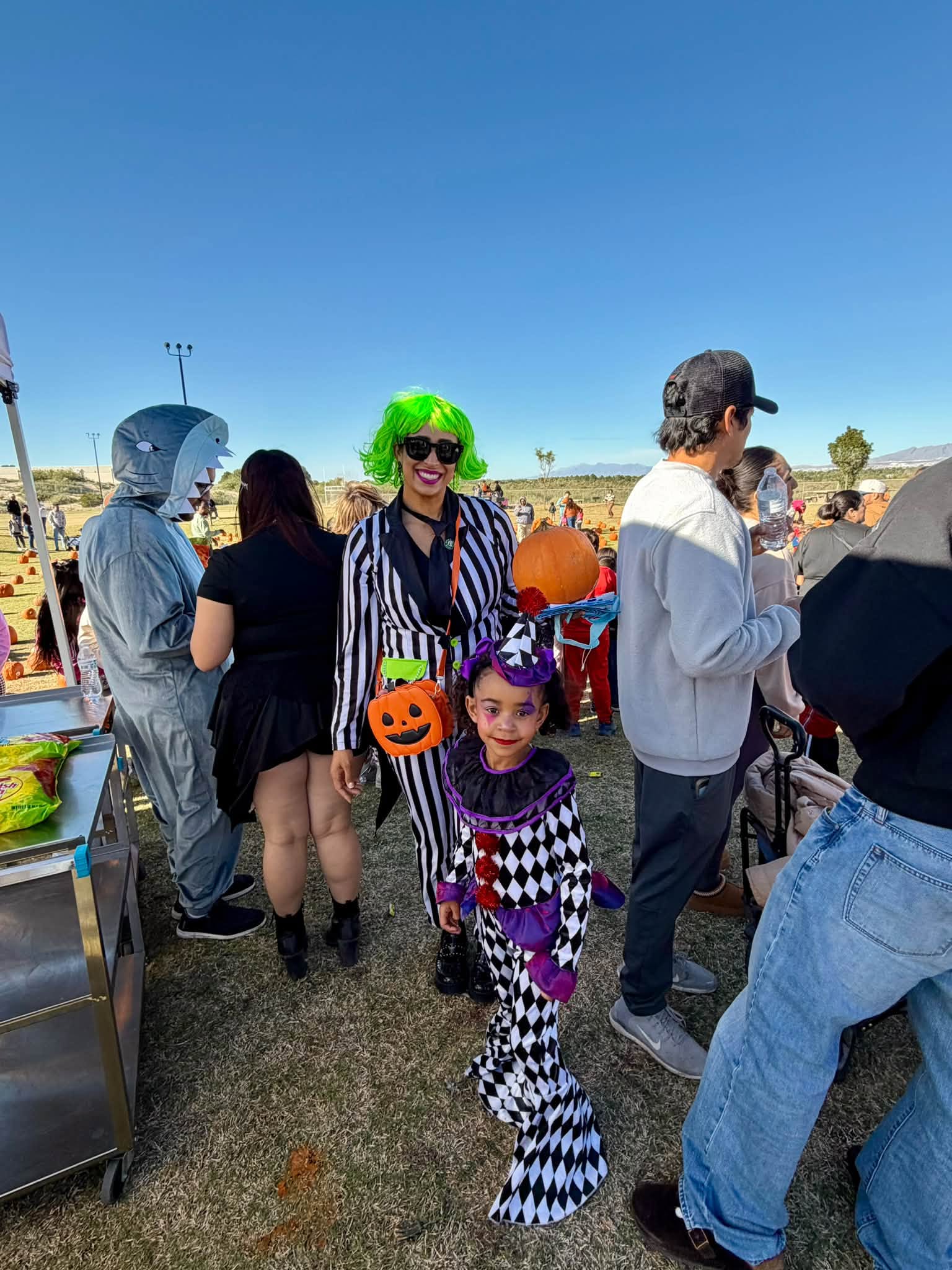 Festivalgoers in costume, including a young clown and a shark