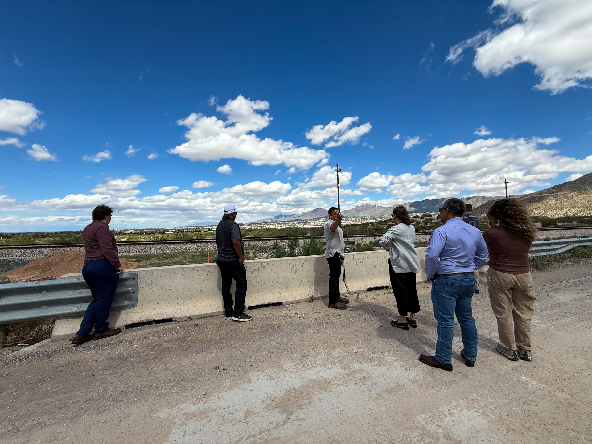 Tour participants overlooking the area and railroad with the mountains in the distance