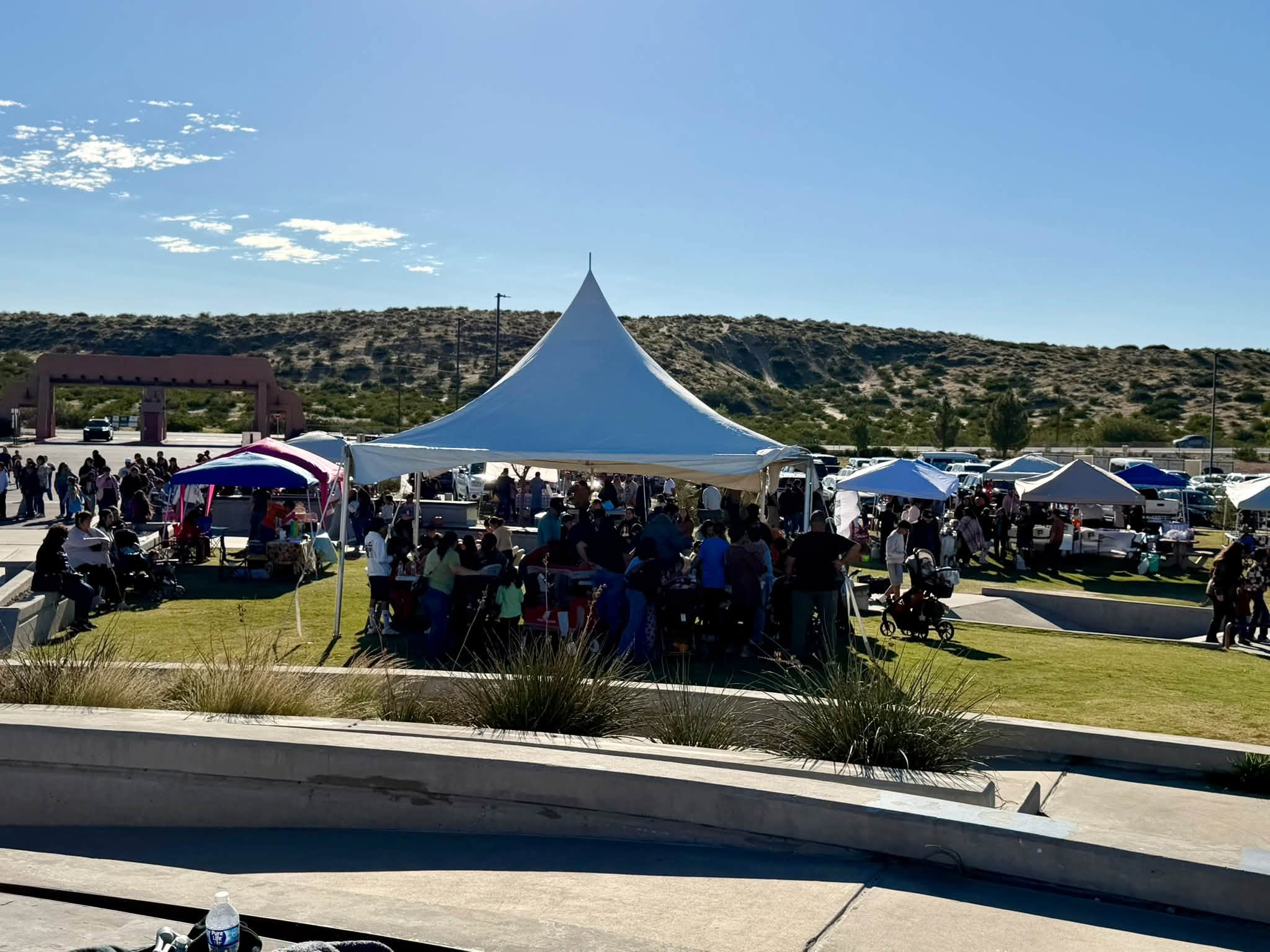 Crowds gather around the festival tent and vendor booths