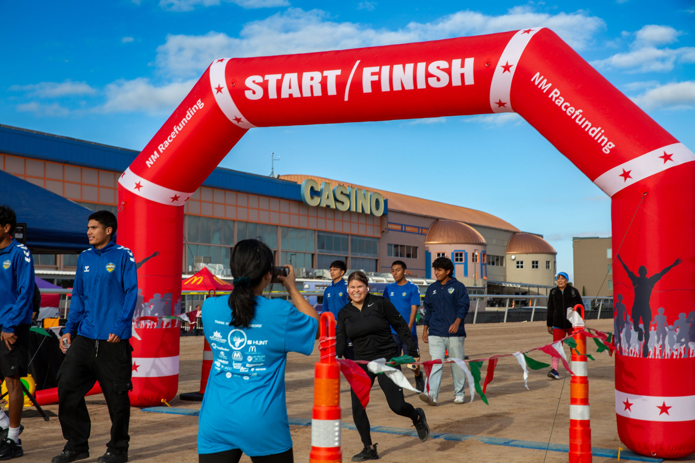 Participants cross under the start/finish arch at Sunland Park Racetrack and Casino during the 11th Annual Walk/Run for Kids