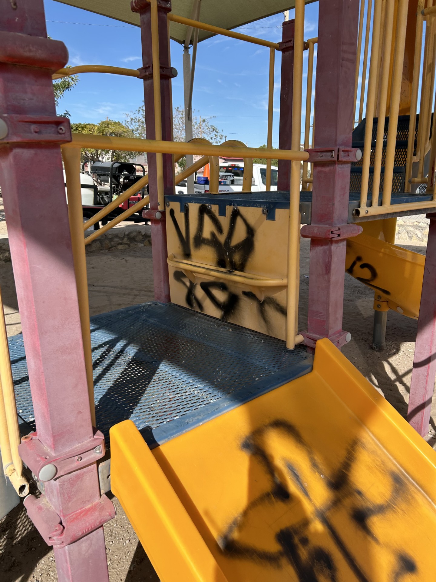 Playground panel covered in black spray paint