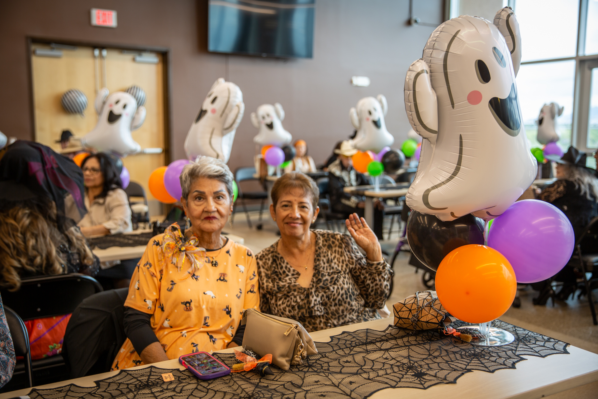 Guests seated at a decorated table with Halloween balloons