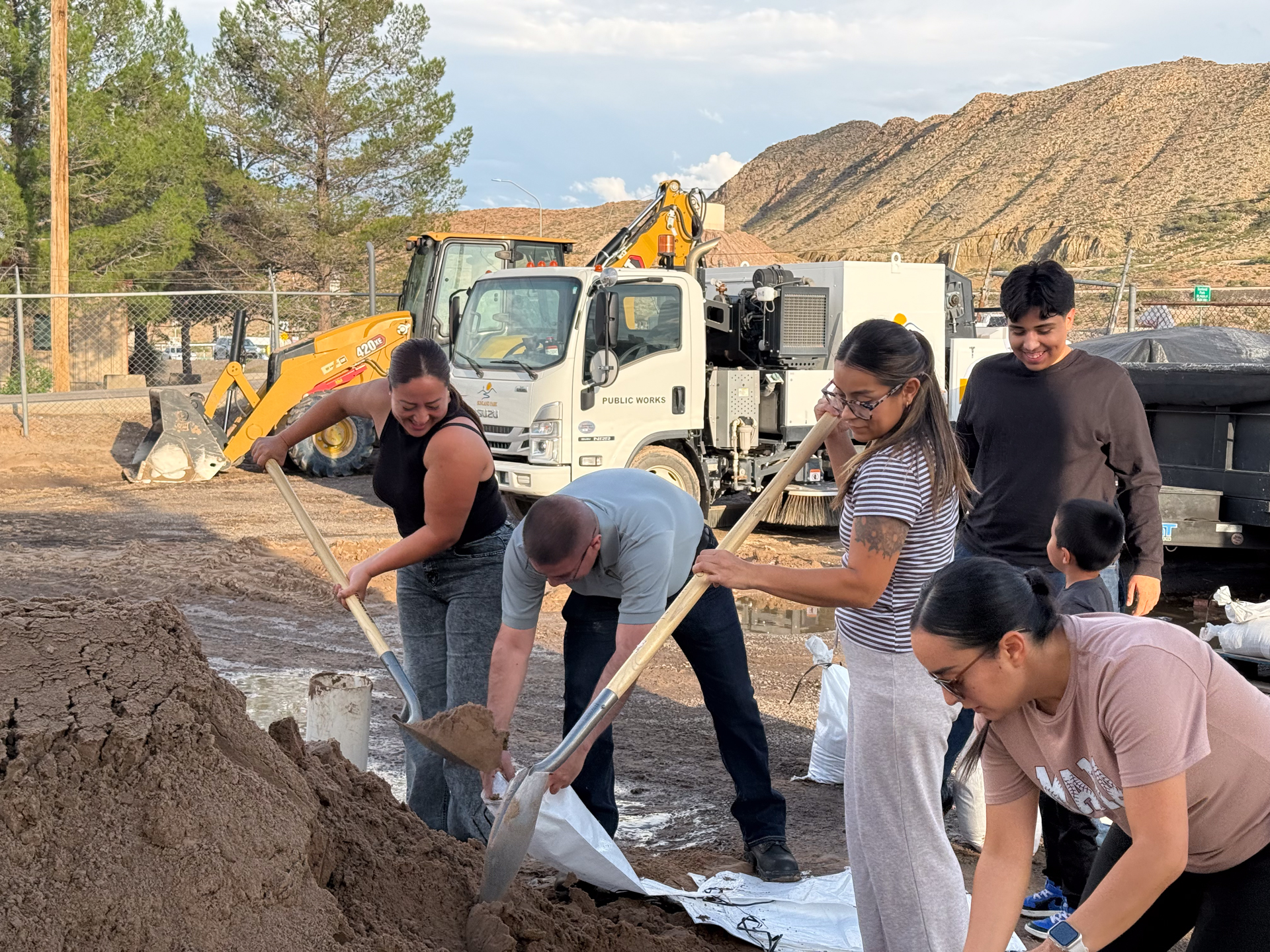 Residents fill sandbags together