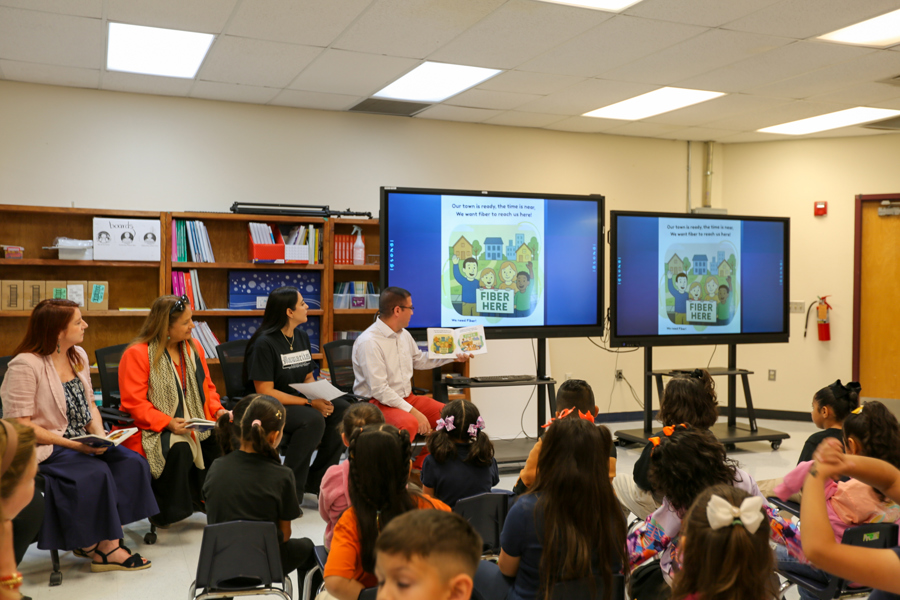 Each page of the book appears on the big screens so every student can follow along.