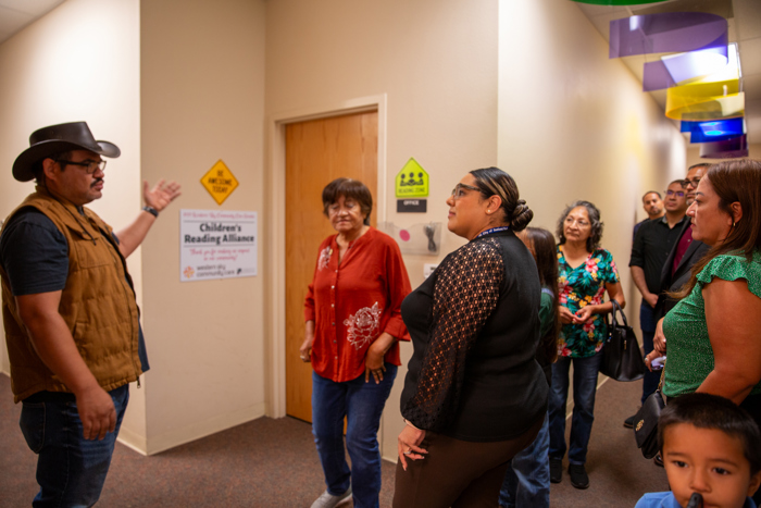 The group moves through the hallway during the facility tour.