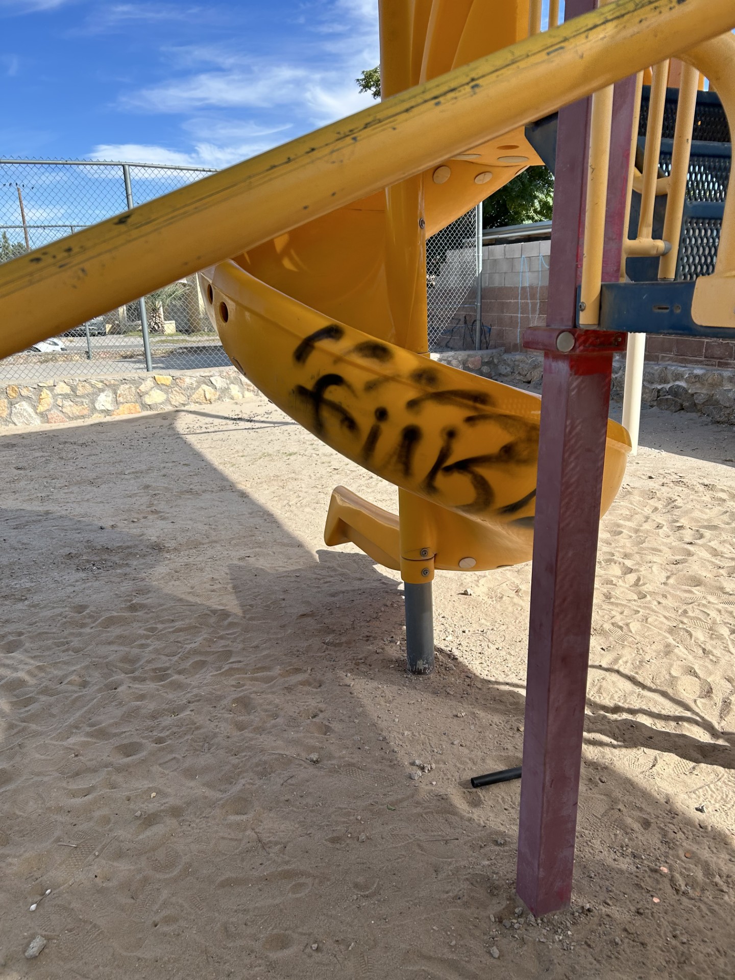 Spiral slide tagged with black spray paint