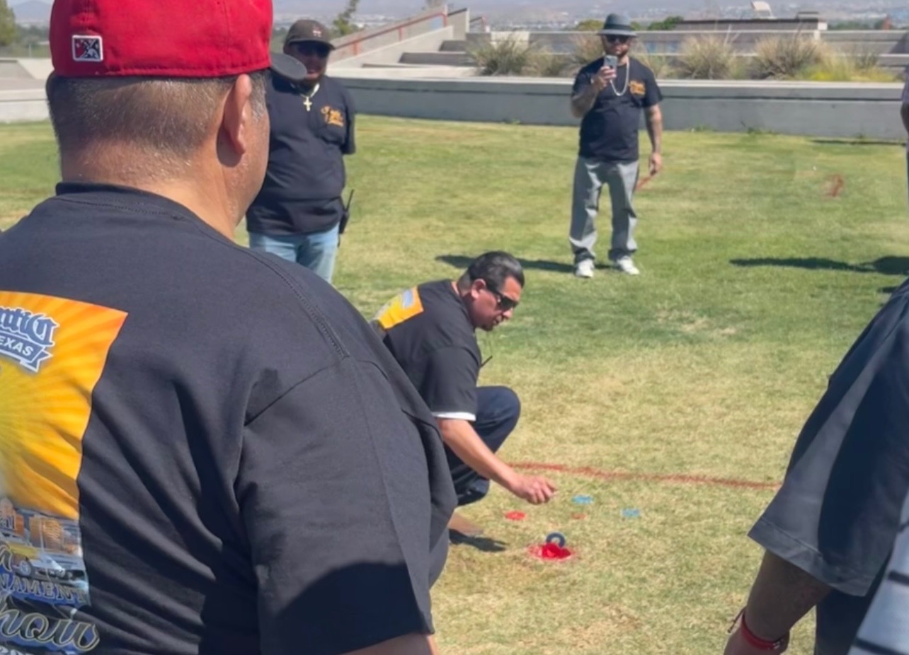 Washers land around the hole inside the painted square during last year's tournament