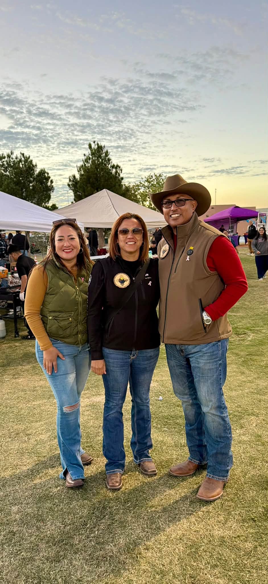 Festival guests pose for a photo at sunset