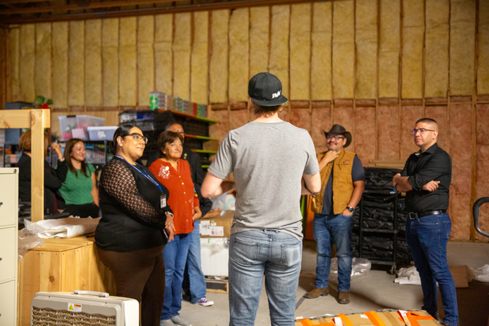 The group gathers inside the warehouse.