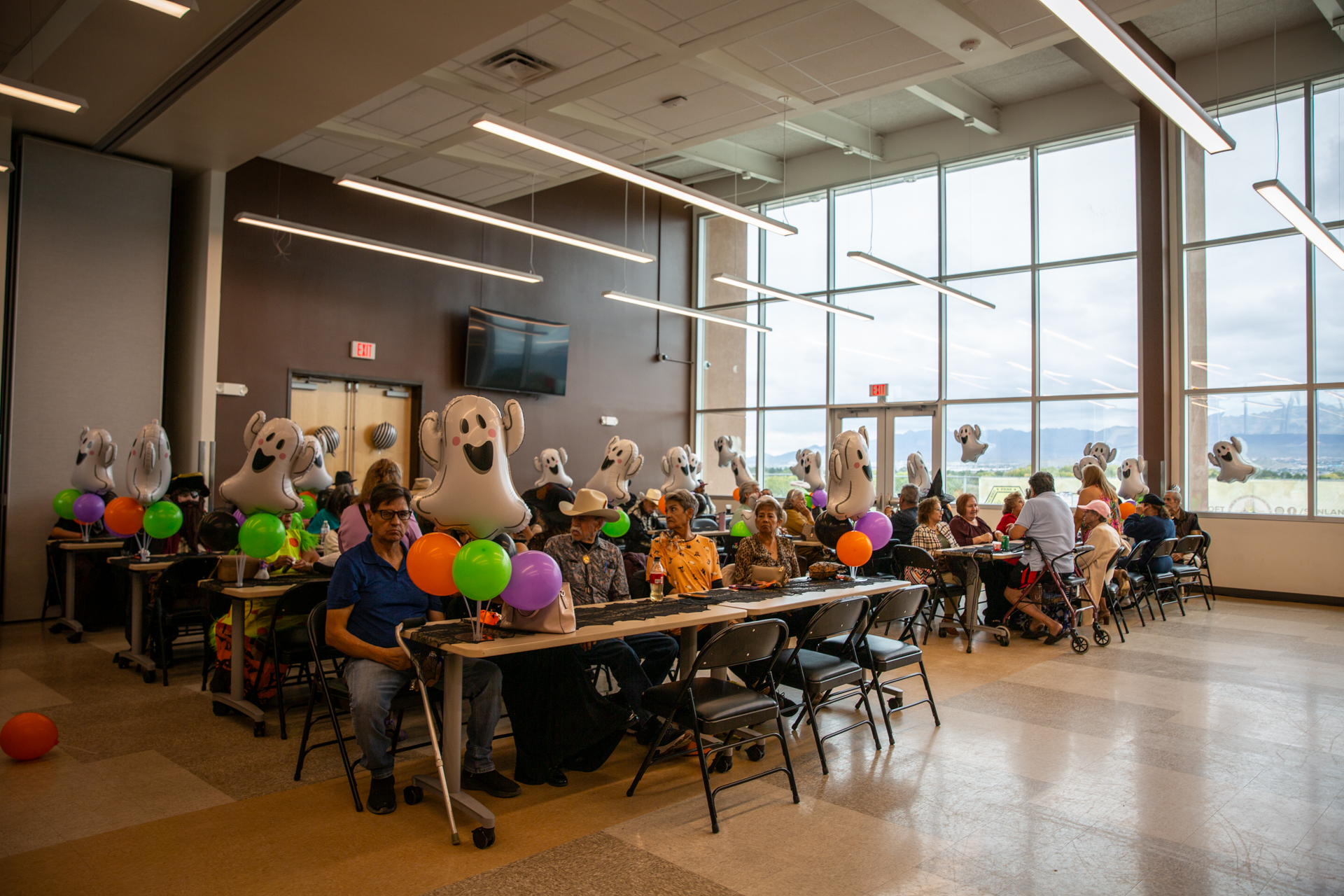 The Senior Center hall decorated for the Halloween Dance, with tables set and guests arriving